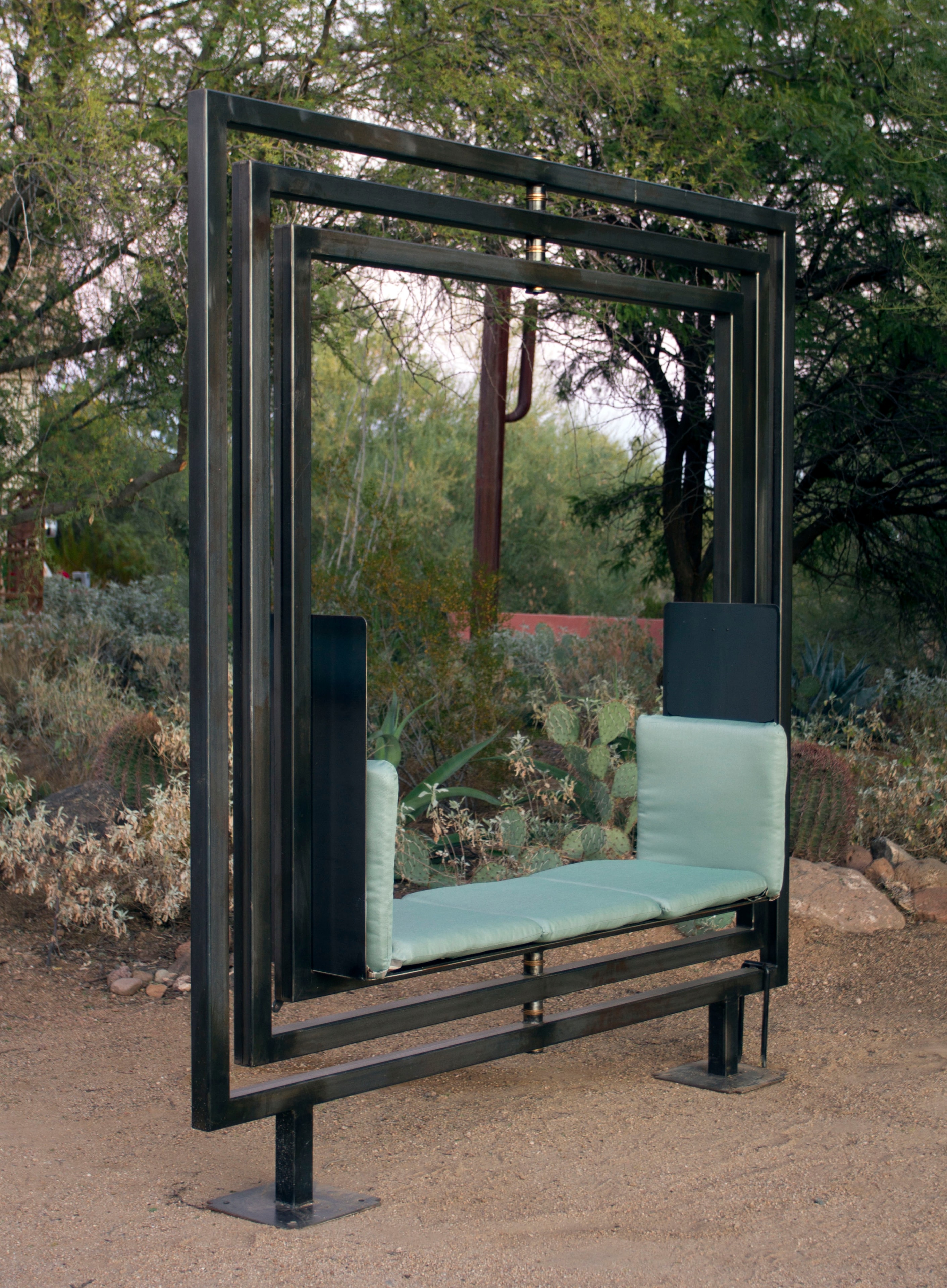 Etazin Square steel frame with mint cushions in desert garden at dusk